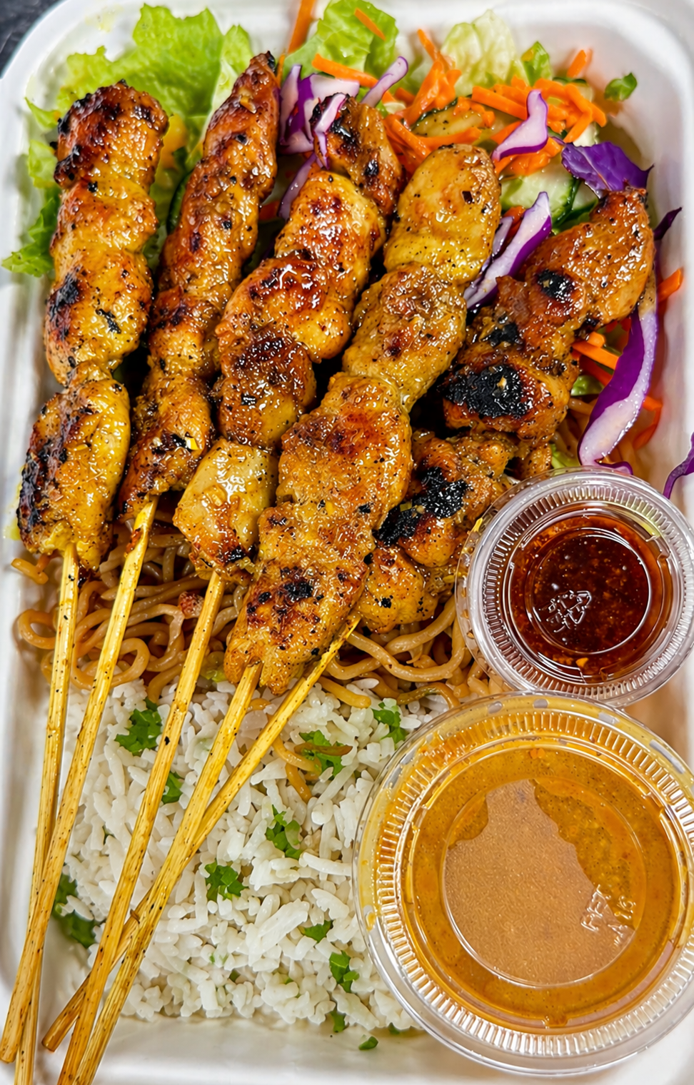 Chicken Satay Meal with rice, slaw and sauces